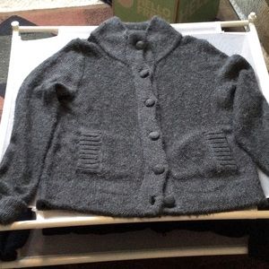 Women’s gray cardigan knit warm sweater with covered buttons.